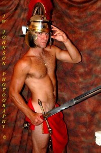 Roman warrior adjusts helmet